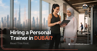 A certified coach guiding a client when hiring a personal trainer in Dubai.